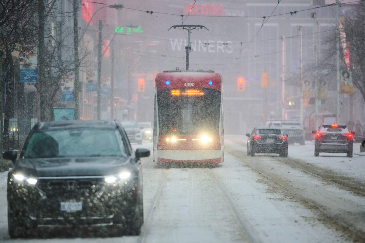 Streetcars make their way through a snow storm on Boxing Day in Toronto, on Friday, Dec. 26, 2025. 