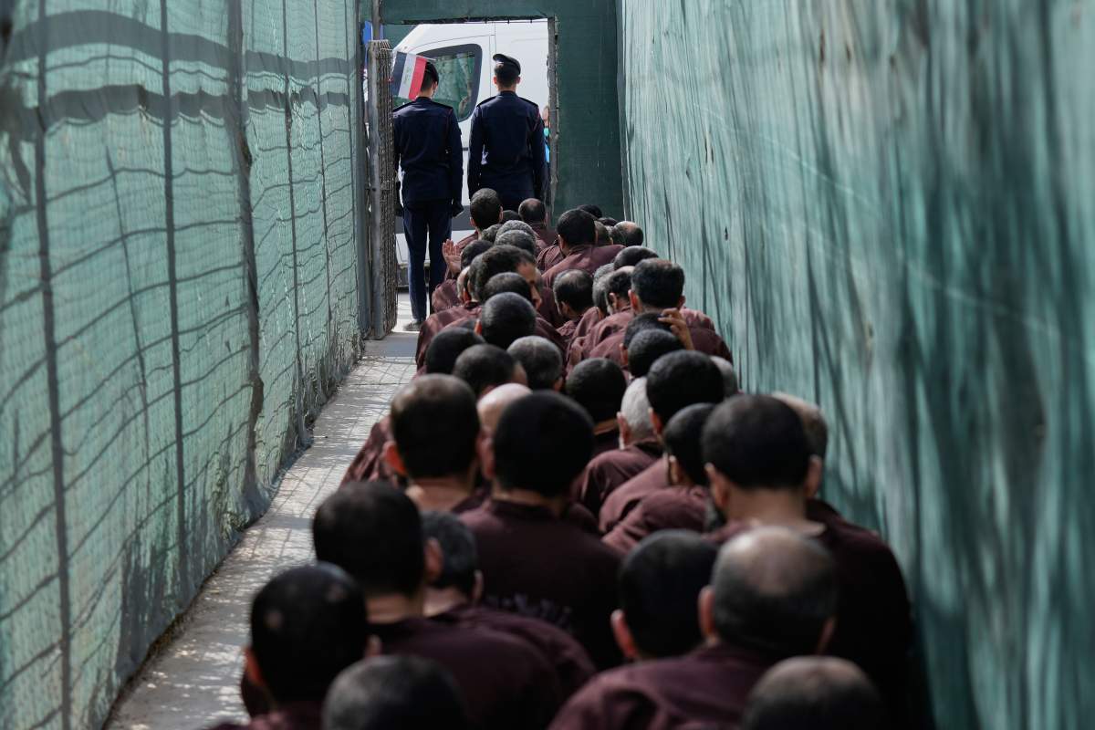 Iraqi security forces lead suspected Islamic State militants for questioning after they were transferred from Syria to Iraq, at Al-Karkh Central Prison in Baghdad, Iraq, Feb. 12, 2026. (AP Photo/Hadi Mizban).