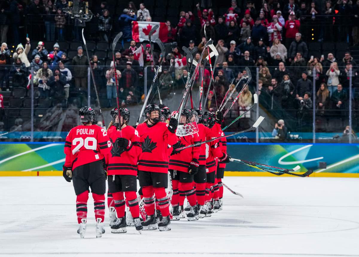 Team Canada players celebrate defeating Switzerland in the women’s ice hockey semifinals match at the 2026 Milano Cortina Olympic Games in Milan, Feb. 16, 2026.