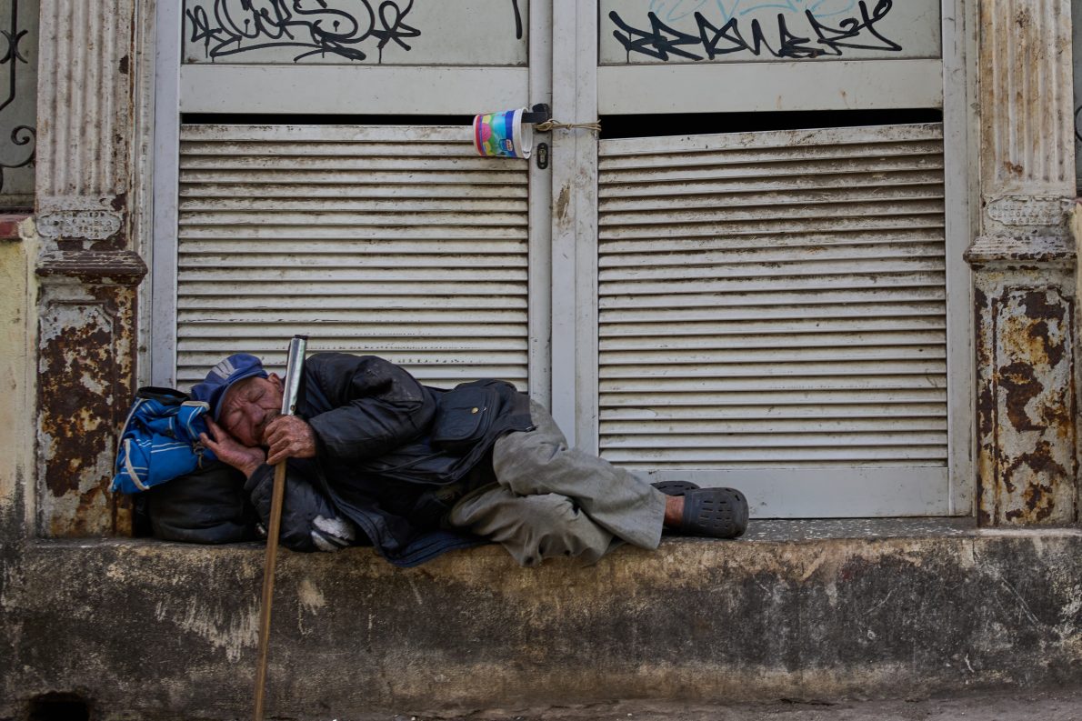 A man sleeps on a street in Havana, Tuesday, Feb. 24, 2026. (AP Photo/Ramon Espinosa).