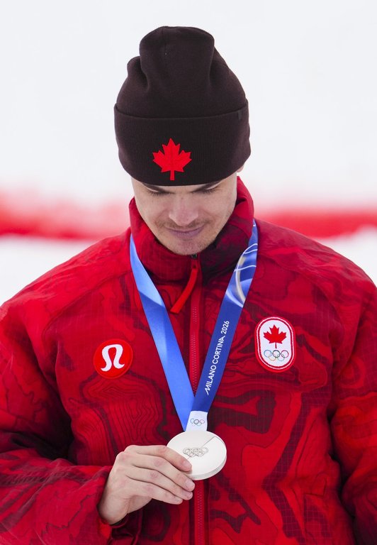 Mikael Kingsbury from Deux-Montagnes, Que., celebrates silver in the men's moguls at the Milano Cortina 2026 Winter Olympic Games in Livigno, Italy on Thursday, Feb. 12, 2026. THE CANADIAN PRESS/Sean Kilpatrick.