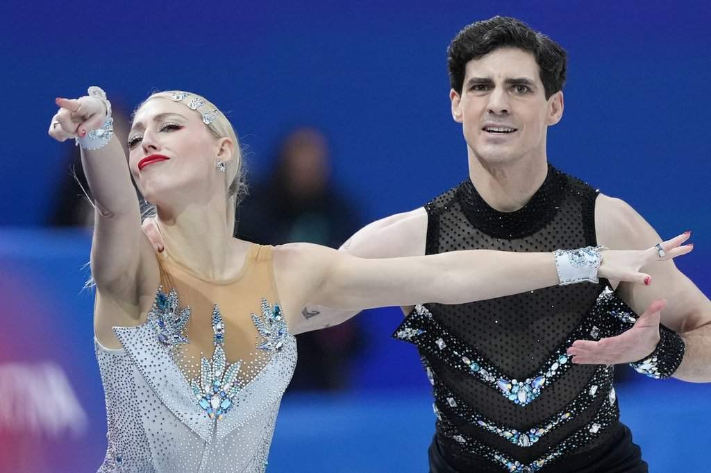 Piper Gilles and Paul Poirier of Canada compete during the figure skating ice dance team event at the 2026 Winter Olympics, in Milan, Italy, Friday, Feb. 6, 2026. (AP Photo/Stephanie Scarbrough).