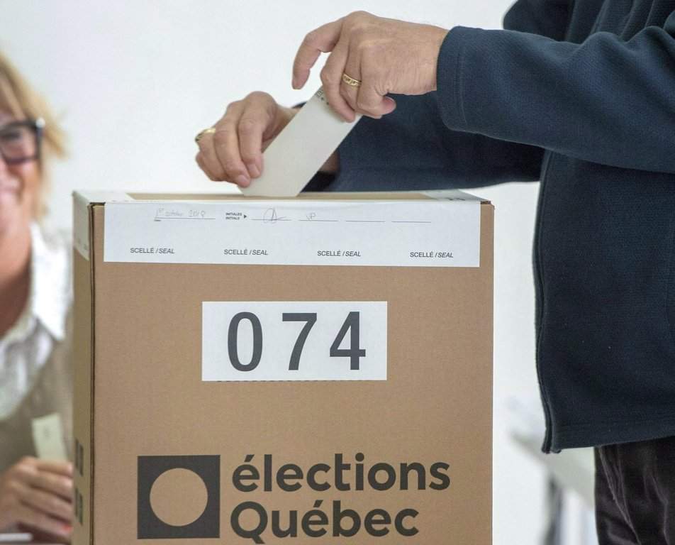 A voter casts his ballot Monday, Oct. 1, 2018, in L'Assomption, Que., as Quebecers go to the polls in the provincial election. 