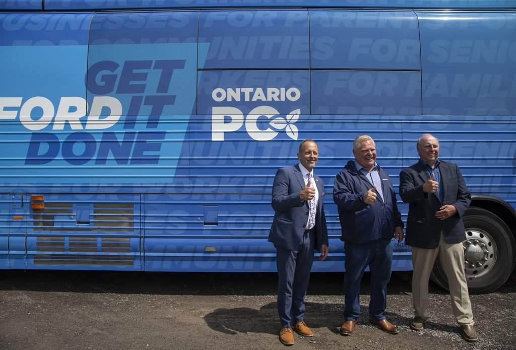 Niagara Falls Mayor Jim Diodati, left, and Ontario PC candidate for Niagara Falls Bob Gale, right, join Ontario Premier Doug Ford during a campaign stop in Niagara Falls, Ontario Friday, May 20, 2022. 