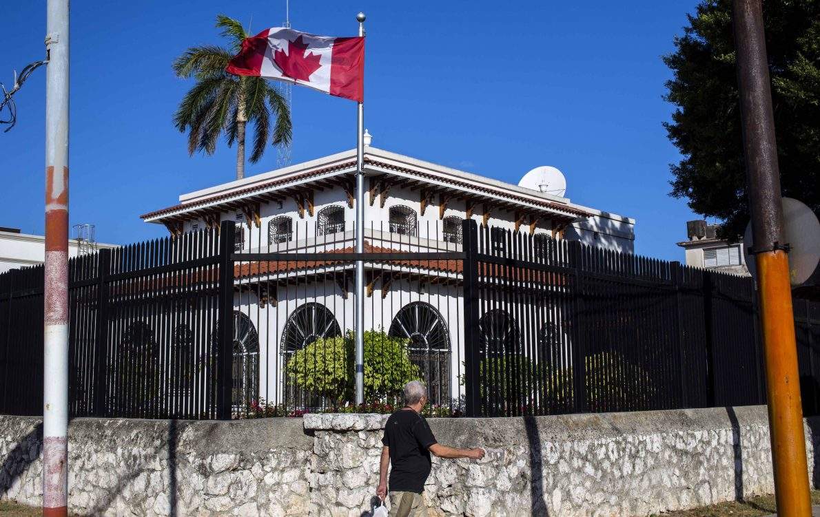 Man walks beside Canada's embassy in Havana, Cuba.