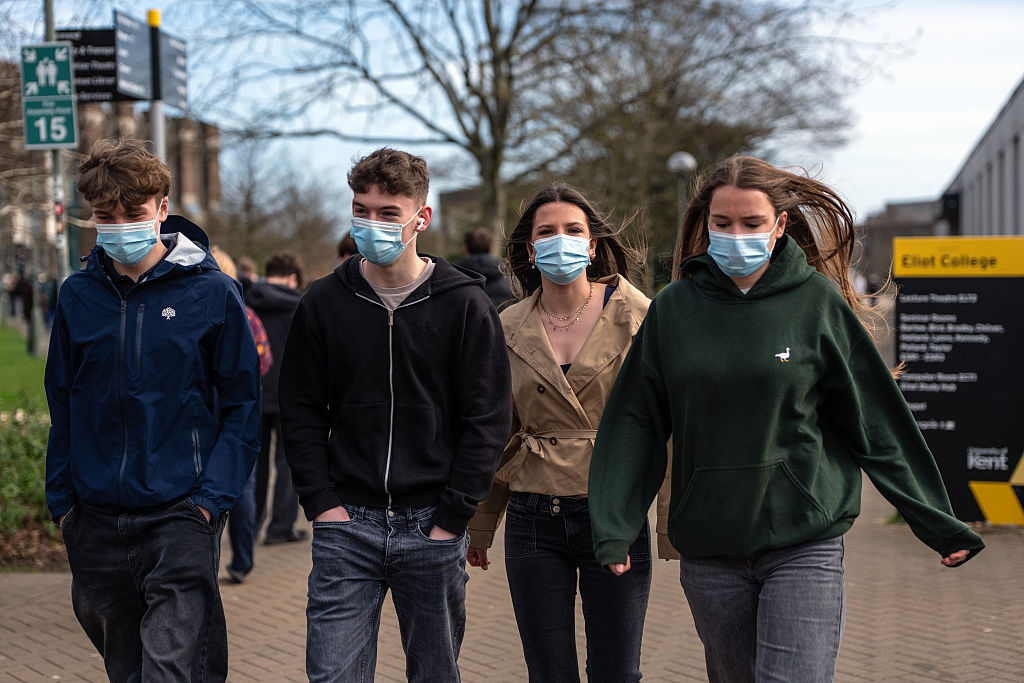 Students wearing face masks walk through the University of Kent in Canterbury campus after an outbreak of meningitis caused the deaths of two people, on March 16, 2026, in Canterbury, United Kingdom.