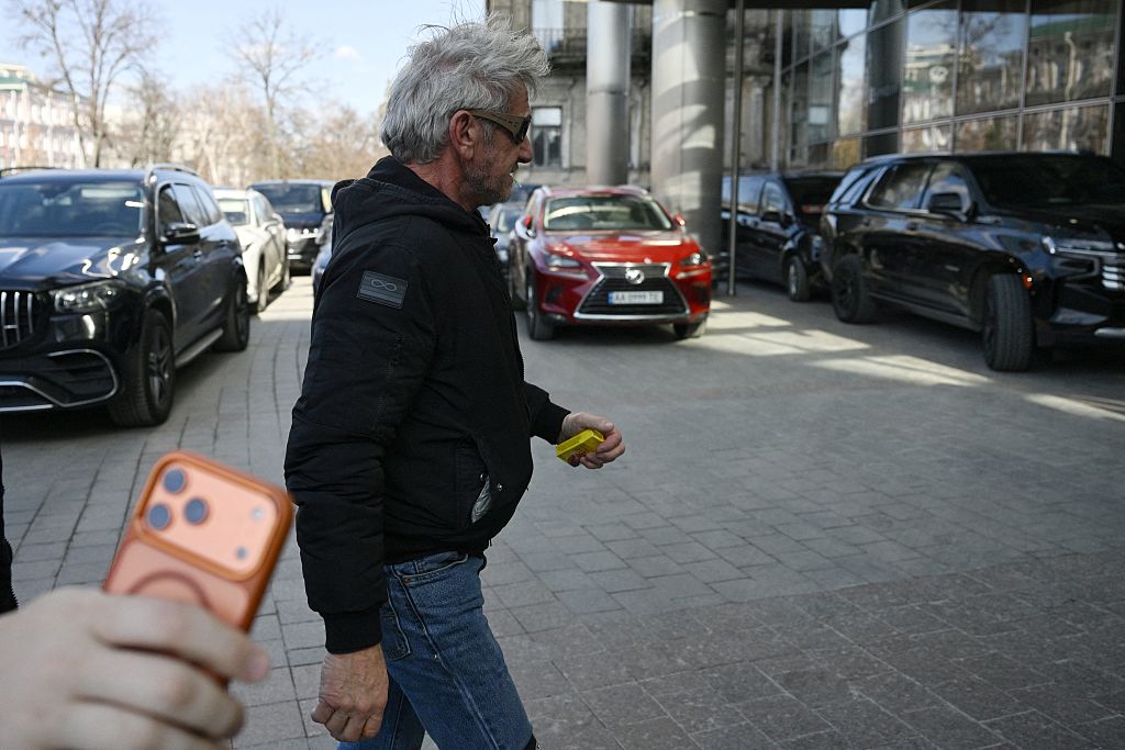 Sean Penn walks down a street in Kyiv on March 16, 2026, amid the Russian invasion of Ukraine. He is in Ukraine to show support to the war-torn country, a senior Ukrainian official told AFP. Penn -- a vocal advocate for Ukraine who had visited the country several times -- has won his third acting Oscar but was not at the ceremony.