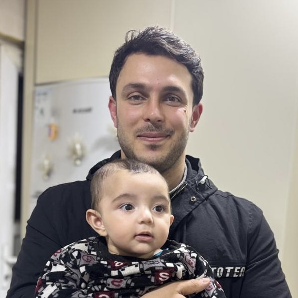 Walat Tahir, holding his son, was killed in a Saturday drone strike, Erbil, Iraq, March 9, 2026.