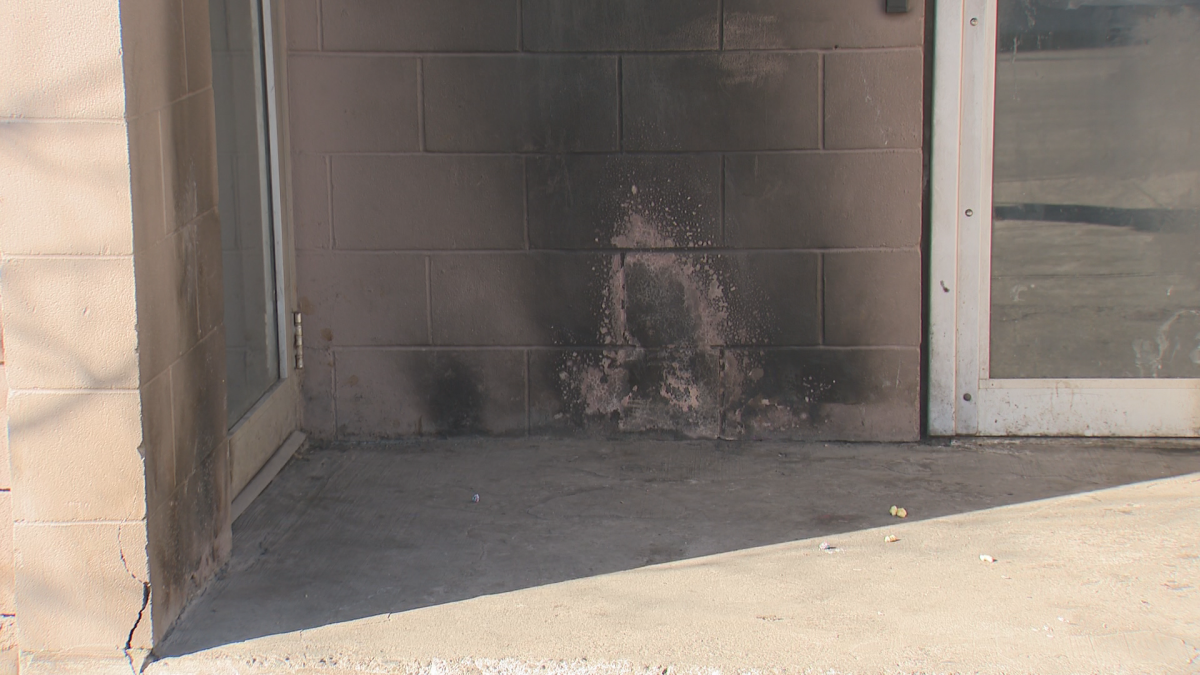 Remnants of a fire set in the alcove of a business