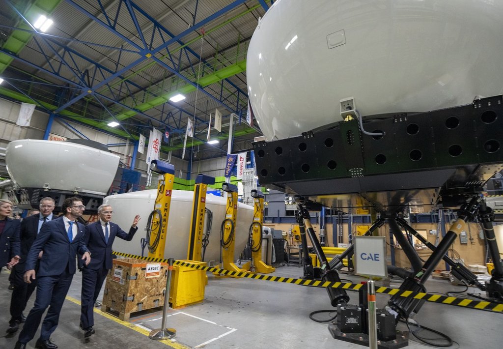 Prime Minister Mark Carney, right, and CAE Inc. chief executive Matthew Bromberg tour company facilities in Montreal, on Tuesday, Feb. 17, 2026. THE CANADIAN PRESS/Christinne Muschi.