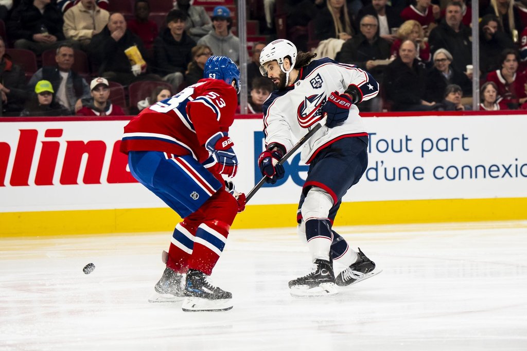 Columbus Blue Jackets' Kirill Marchenko (27) shoots past Montreal Canadiens' Noah Dobson (53) to score during second period NHL hockey action in Montreal on Saturday, April 11, 2026. THE CANADIAN PRESS/Christopher Katsarov.