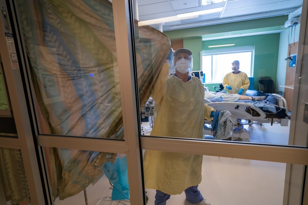 Nurses close the curtains of a patients room in the Intensive Care Unit at Surrey Memorial Hospital in Surrey, B.C., Friday, June 4, 2021. 