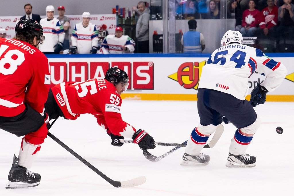 Canada's Mark Scheifele, centre, scores a goal during the 2026 IIHF Men's Ice Hockey World Championship preliminary round group B game between Canada and Norway, in Fribourg, Switzerland, Thursday, May 21, 2026. (Anthony Anex/Keystone via AP).