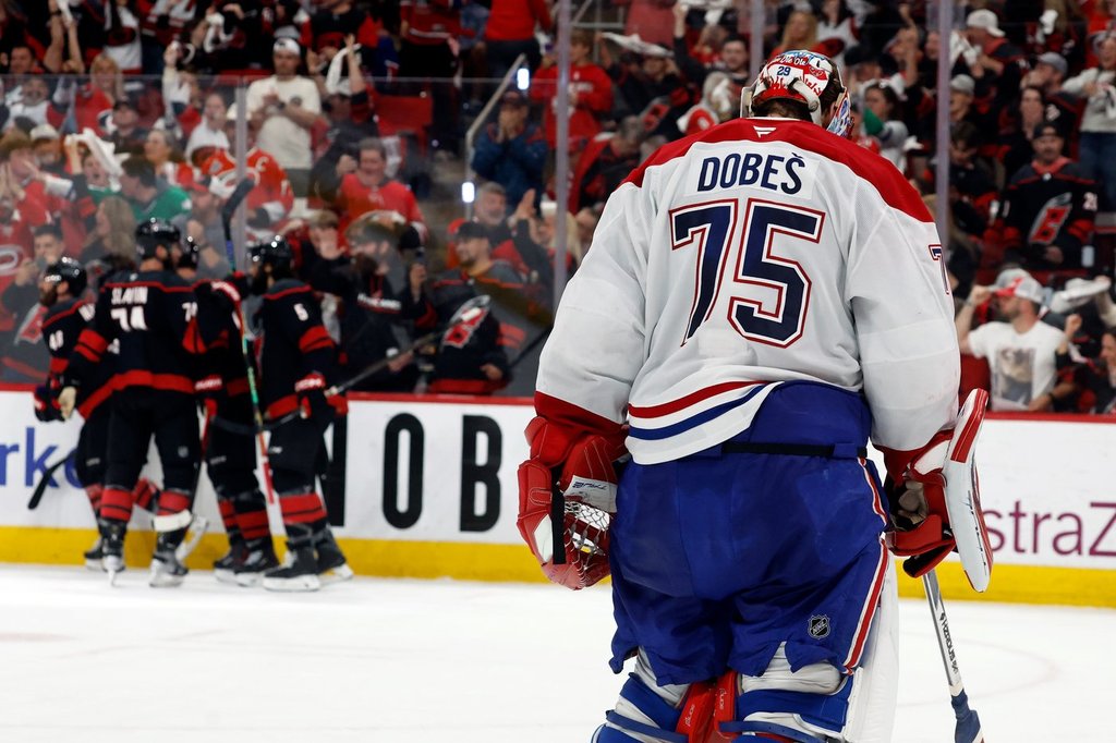 Carolina Hurricanes players celebrate after a goal by Nikolaj Ehlers as Montreal Canadiens goaltender Jakub Dobes (75) returns to the net during the second period in Game 2 of the Eastern Conference final NHL playoff series in Raleigh, N.C., Saturday, May 23, 2026.