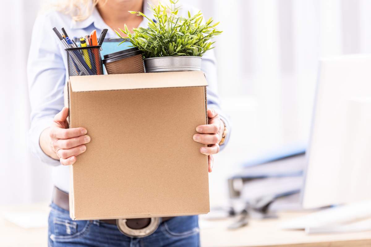 A businesswoman carrying her office supplies in a cardboard box. Simple Images/Getty Images