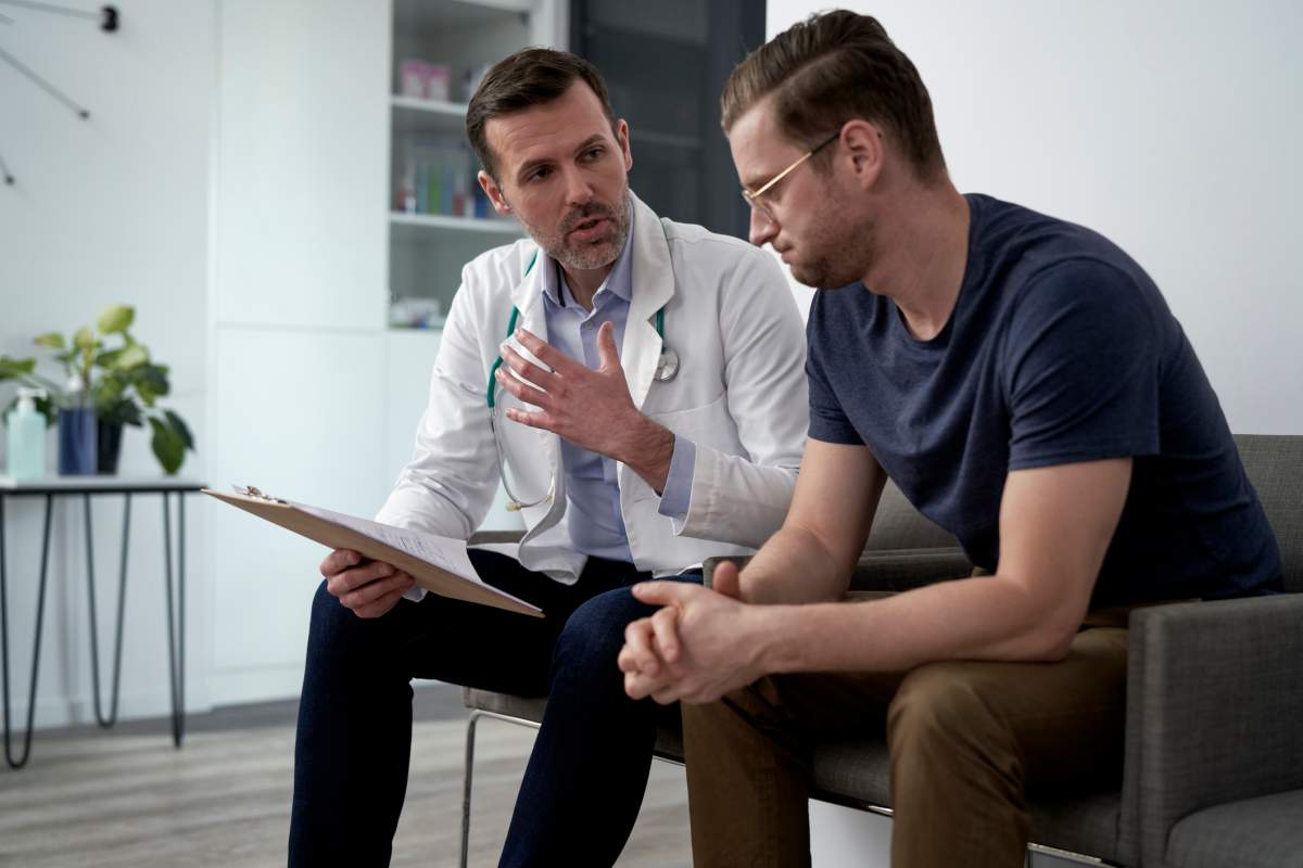 A man with vertigo listens to his doctor during an appointment. Westend61/Getty Images