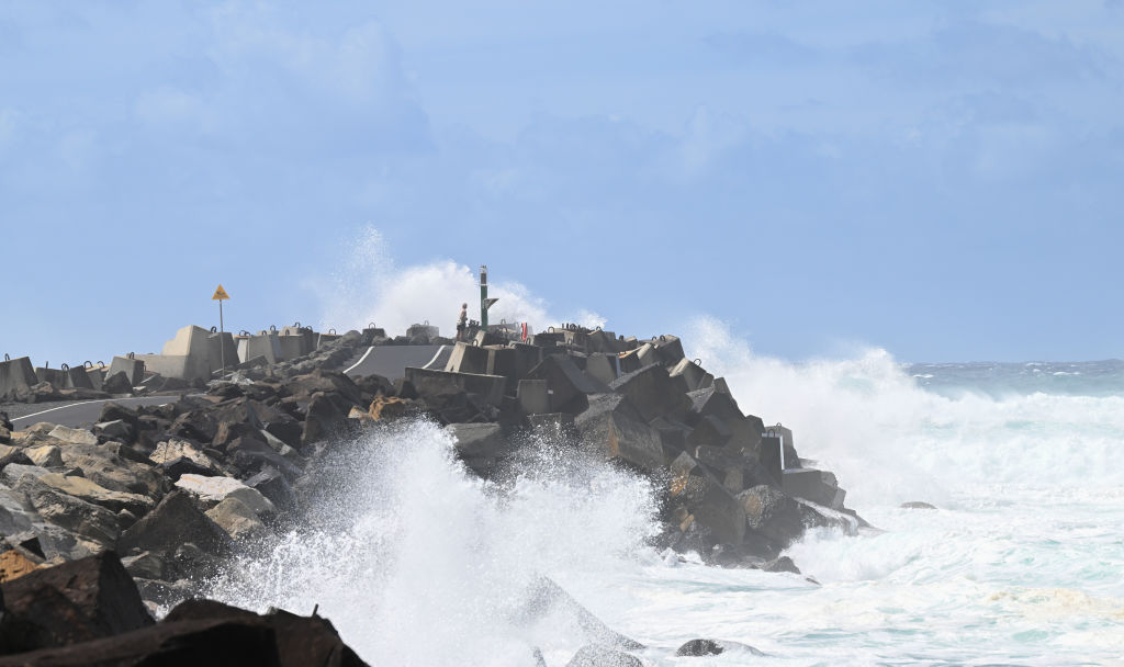 FILE: BALLINA, AUSTRALIA - MARCH 04: A man watches huge waves at North Wall caused by Cyclone Alfred on March 04, 2025 in Ballina, Australia.
