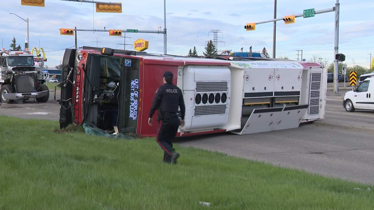 A Calgary Transit bus lies on its side after a collision involving a gravel truck on Tuesday morning at the intersection of Peigan Trail and 26 Street southeast.