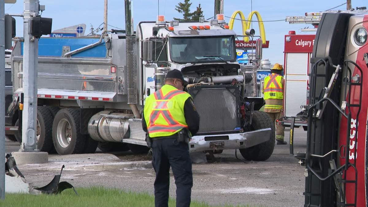 The collision involved a Calgary Transit bus and a semi-truck hauling gravel and caused the bus to flip over on its side.