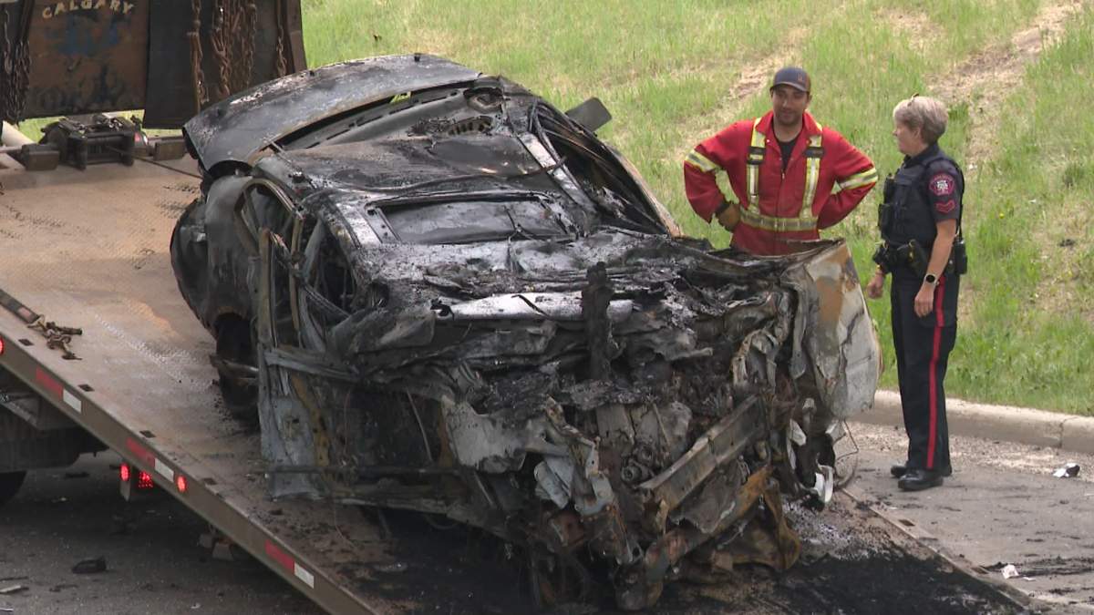 Calgary police prepare to tow away the mangled wreckage of a vehicle that claimed the life of the driver in an early Tuesday morning crash on Crowchild Trail.
