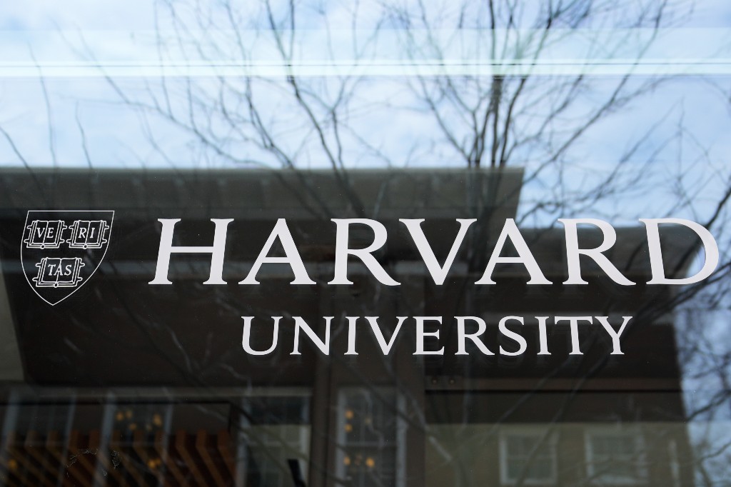 The Harvard University logo is displayed on a building at the school, Tuesday, April 15, 2025, in Cambridge, Mass.