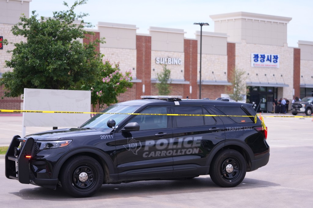 Officials respond to the scene of a shooting Tuesday, May 5, 2026, at K Towne Plaza in Carrollton, Texas.