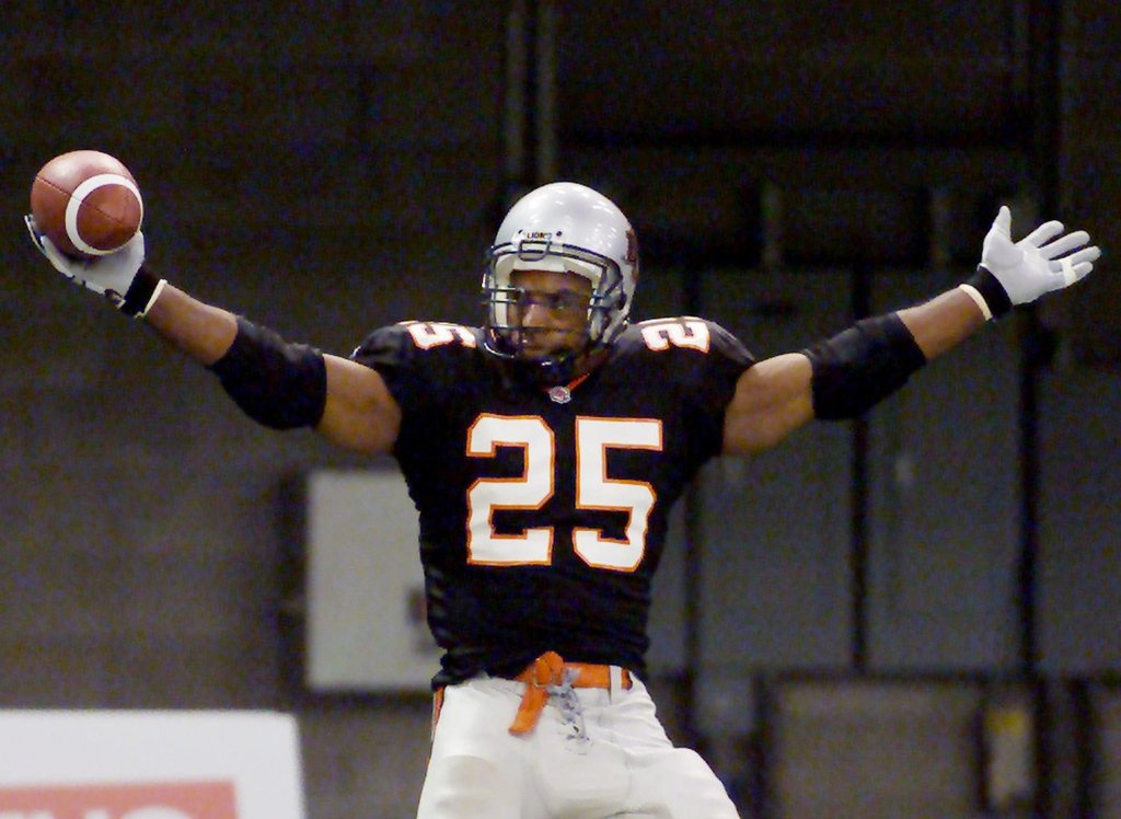 BC Lions Sean Millington (25) celebrates one of two touchdowns he scored in the second quarter of CFL action against the Hamilton Tiger-Cats in Vancouver Thursday, July 18, 2002. The Lions led 23-14 at the half. (CP PHOTO/Richard Lam).