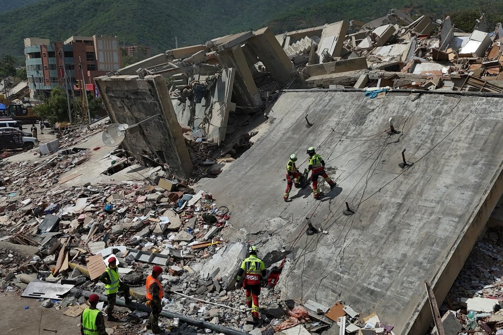 Mexican Army rescue workers search for people trapped in collapsed buildings after earthquakes struck La Guaira, Venezuela, Sunday, June 28, 2026.