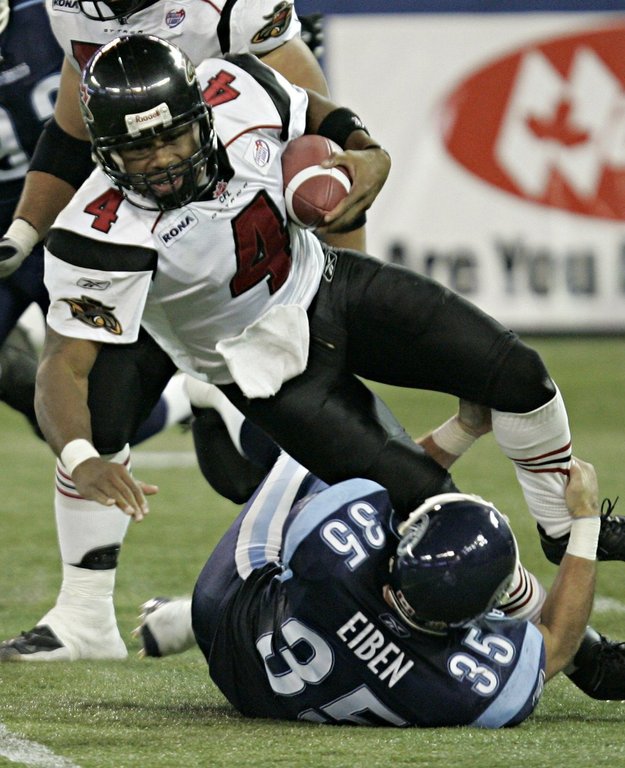 Ottawa Renegades Kerry Joseph is tackled by Toronto Argonauts Kevin Eiben during third quarter CFL action in Toronto, Wednesday Sept. 28, 2005. (CP PHOTO/Adrian Wyld).