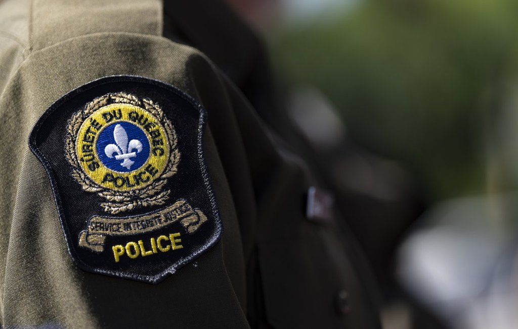 A Surete du Quebec emblem is seen on an officer’s uniform in Montreal, Tuesday, Aug. 22, 2023. 