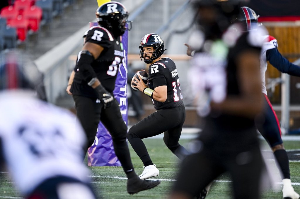 Ottawa Redblacks quarterback Jake Maier (13) looks for a pass against the Montreal Alouettes during first half CFL pre-season action in Ottawa, on Friday, May 29, 2026. THE CANADIAN PRESS/Spencer Colby.