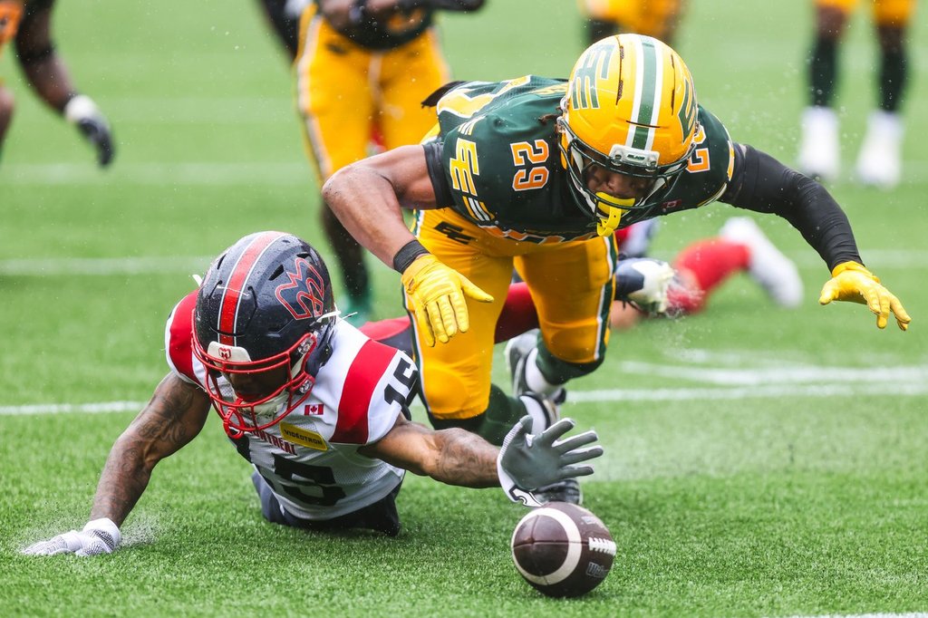 Edmonton Elks' JJ Ross (29) pounces on the ball after Montreal Alouettes' Alexander Hollins (15) loses control during second half CFL football action in Edmonton on Saturday, June 20, 2026. THE CANADIAN PRESS/Codie McLachlan.