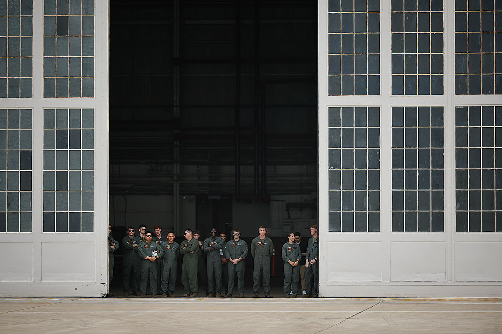 Airmen watch as President Donald Trump and first lady Melania Trump arrive at Lackland Air Force Base before heading off to Kerrville, Texas where they plan to visit with state and local leaders, first responders and victims of last week's flash flooding on July 11, 2025 in San Antonio, Texas.