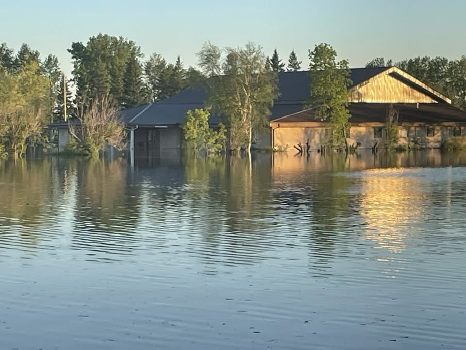 Water nears a home in Swan River, Man. on June 8, 2026.