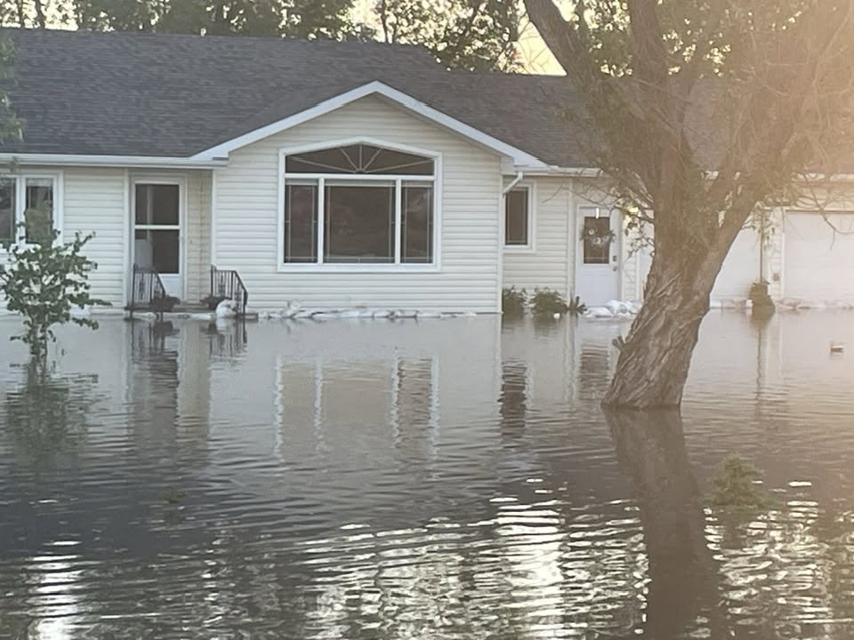 Sandbags line a home in Swan River, Man. after significant flooding on June 8, 2026.