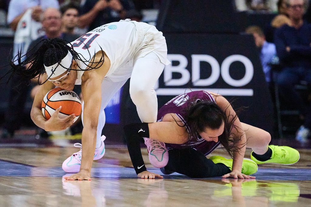 Atlanta Dream's Allisha Gray (15) and Toronto Tempo's Marina Mabrey (3) collide as they vie for the ball during second half WNBA basketball action in Toronto, Friday, July 17, 2026. THE CANADIAN PRESS/Sammy Kogan.