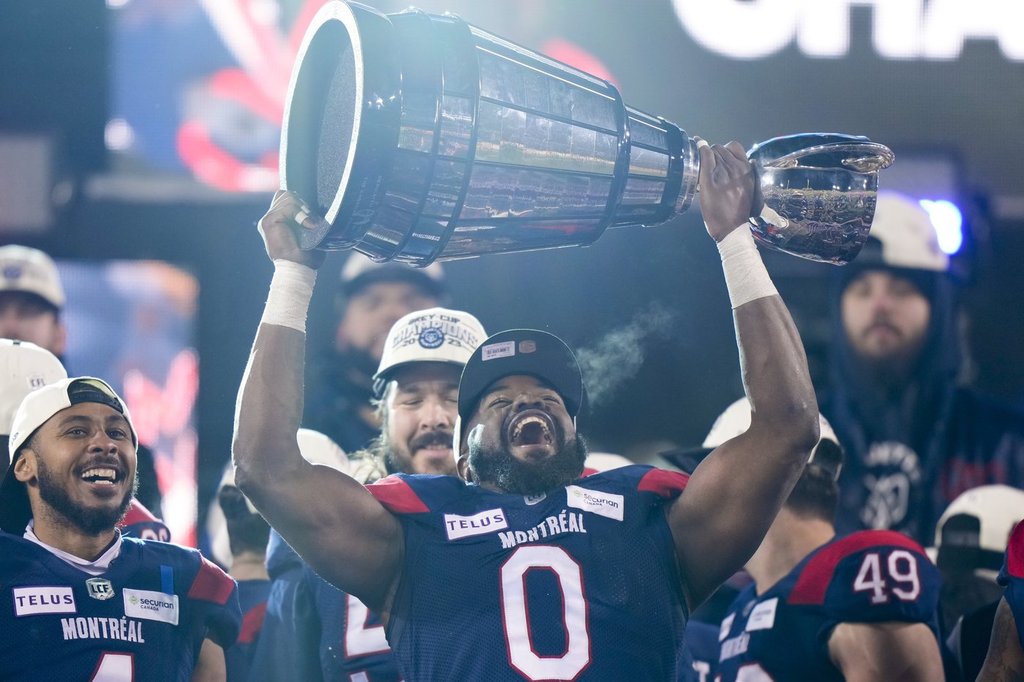 Montreal Alouettes defensive end Shawn Lemon (0) hoists the Grey Cup as the Alouettes celebrate defeating the Winnipeg Blue Bombers in the 110th CFL Grey Cup in Hamilton, Ont., on Sunday, November 19, 2023. THE CANADIAN PRESS/Frank Gunn.