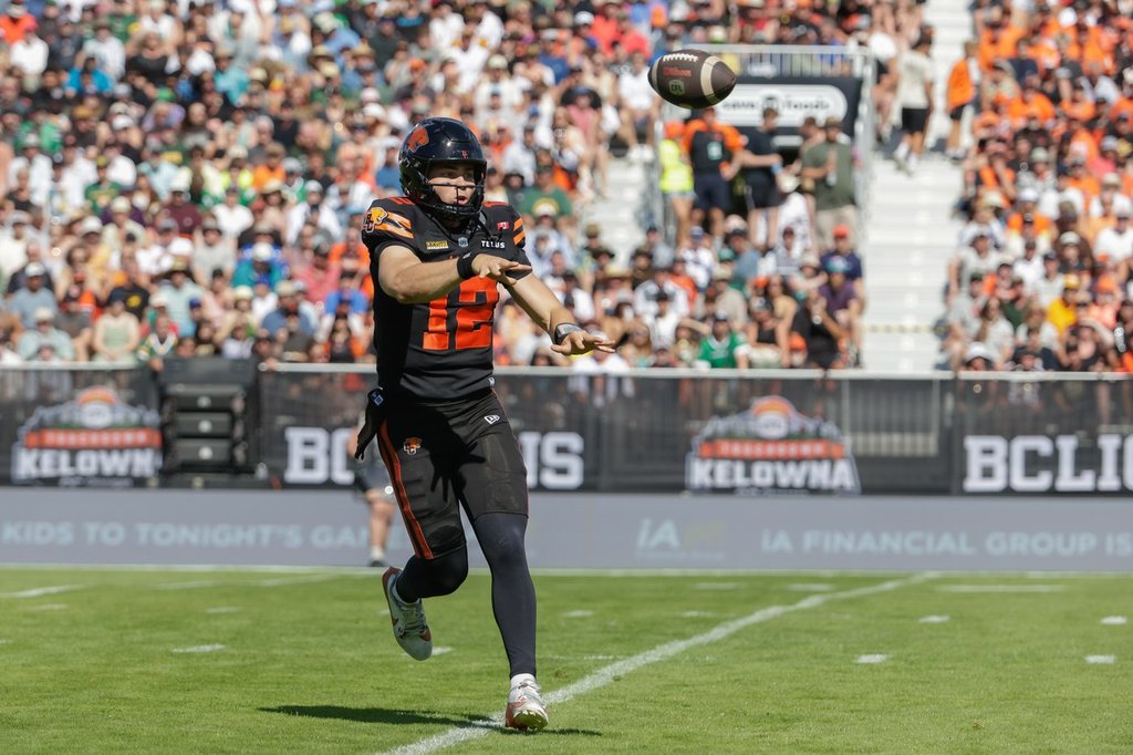 B.C. Lions' quarterback Nathan Rourke (12) throws for a first down against the Edmonton Elks during first-half CFL football action in Kelowna, B.C., on Saturday, July 4, 2026. THE CANADIAN PRESS/Steve Dunsmoor.