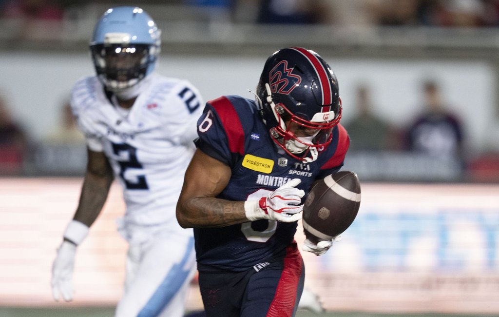 Montreal Alouettes' Tyson Philpot (6) makes the catch and runs in for a touchdown in front of Toronto Argonauts' Tarvarus McFadden (2) during second half CFL football action in Montreal on Friday, June 12, 2026. THE CANADIAN PRESS/Christinne Muschi.