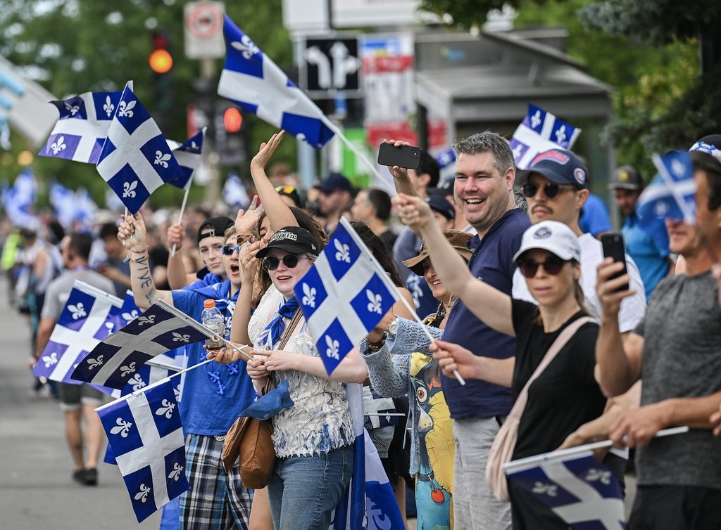 Members of the crowd cheer as they watch the Saint-Jean-Baptiste Day parade in Montreal, on Wednesday, June 24, 2026. 