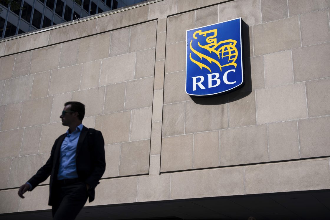 FILE - People walk past the Royal Bank Tower in Montreal on June 19, 2025. RBC has agreed to a proposed class-action settlement of $45 million related to trailing commissions.