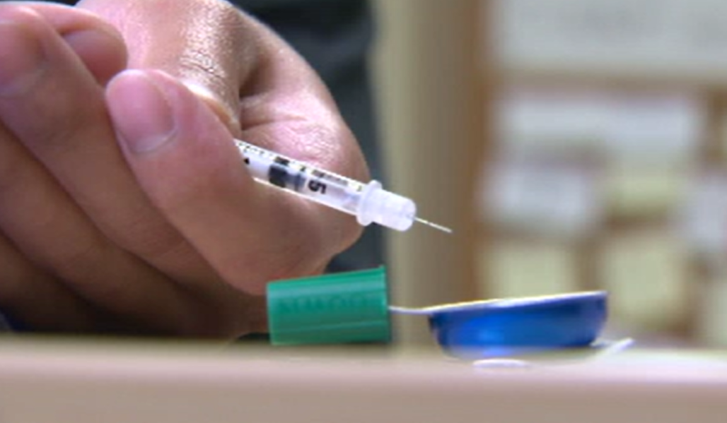 A person holds a needle in Montreal, Que., at a health facility.