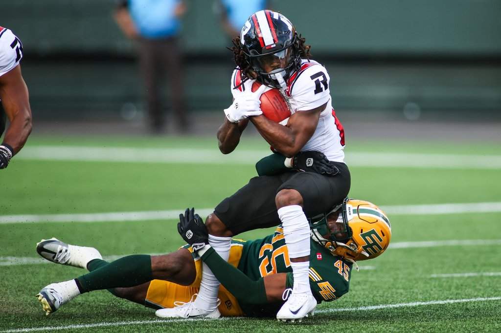 Edmonton Elks' Dariel Djabome (45) tackles Ottawa Redblacks' Kalil Pimpleton (83) during first half CFL football action in Edmonton on Thursday, July 9, 2026. THE CANADIAN PRESS/Codie McLachlan.