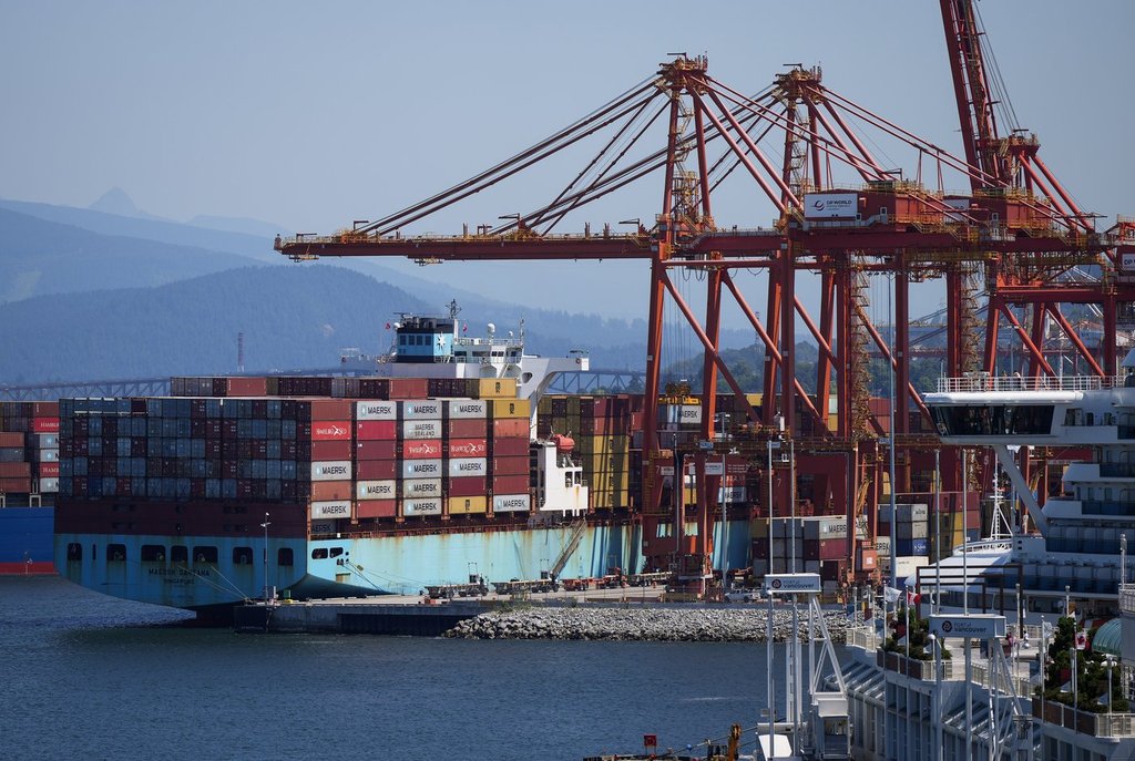 A gantry crane operator removes a container from a cargo ship while docked at port, in Vancouver, on Tuesday, July 16, 2024. THE CANADIAN PRESS/Darryl Dyck.