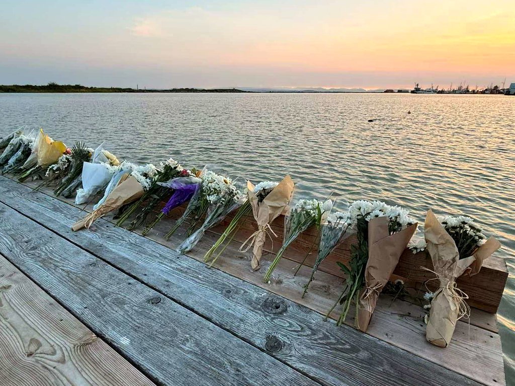 Flowers are seen placed alongside the Imperial Landing Dock in Richmond, B.C., to pay tribute to six people who are presumed drowned following the tragic capsizing of a commercial charter fishing boat in the Strait of Georgia on June 28, 2026.