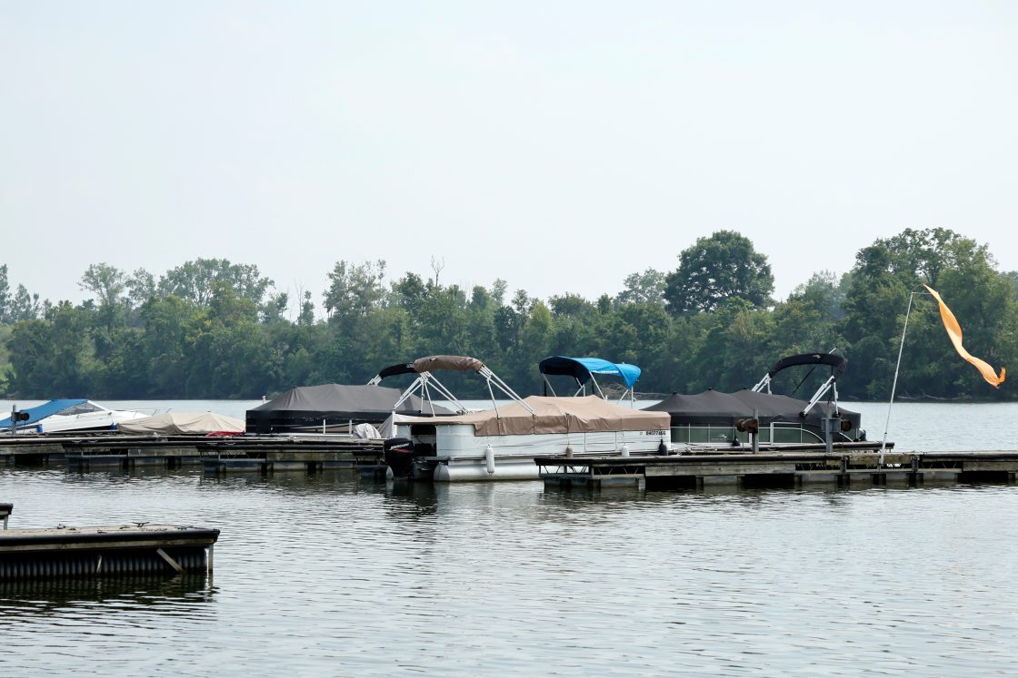 Boats sit moored on the Scioto River near where multiple people died after several of them entered the water to help a person who was struggling to swim, July 20, 2026, in Powell, Ohio.